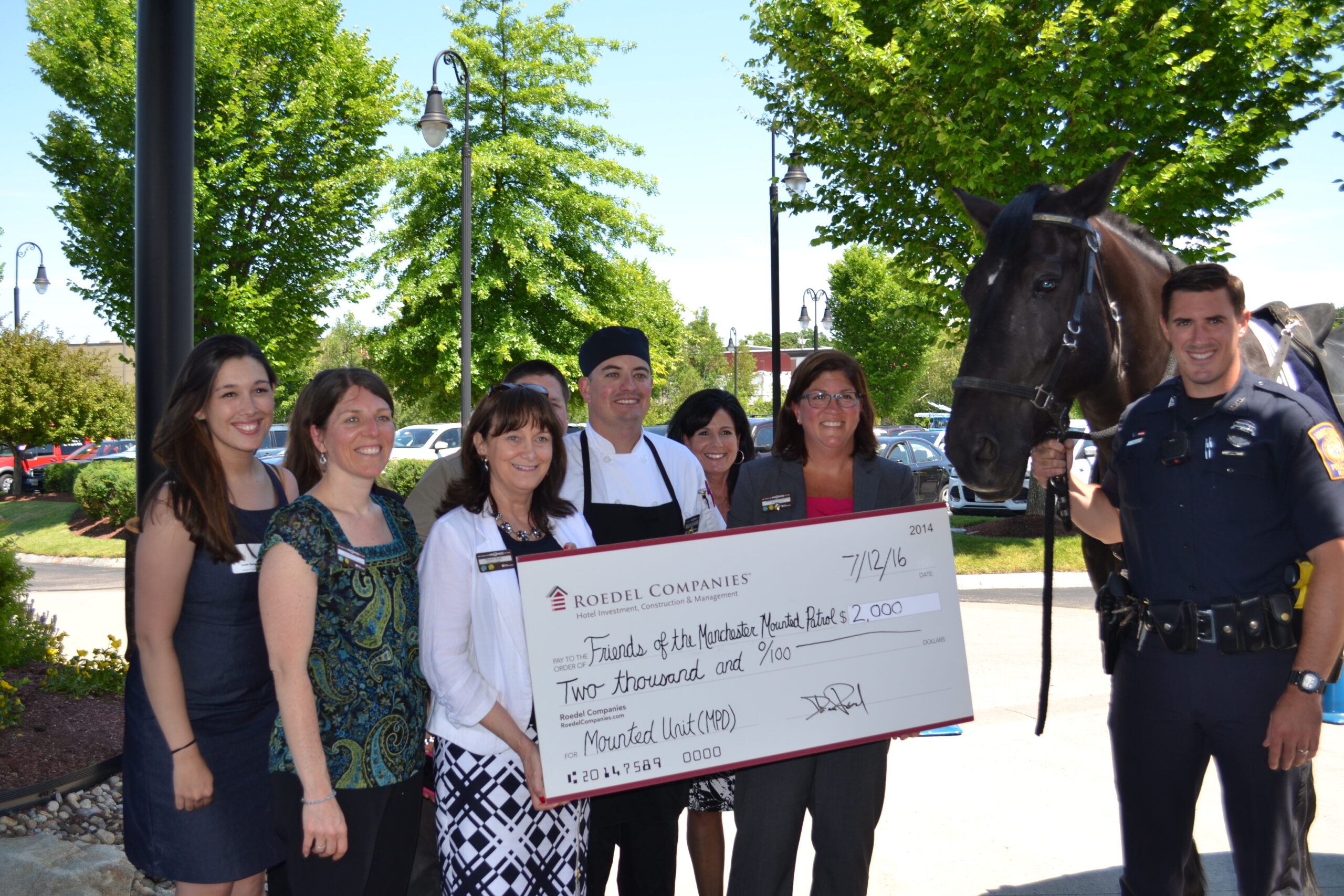 Officer Fred Willis of the Manchester Police Department and his horse Valor were on hand to accept the check from Hilton Garden Inn General Manager Brenda Edwards.