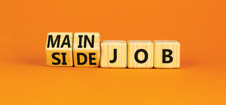 Extra or side job symbol. Turned wooden cubes and changed concept words Side job to Main job. Beautiful orange table orange background, copy space. Business side or main job concept.